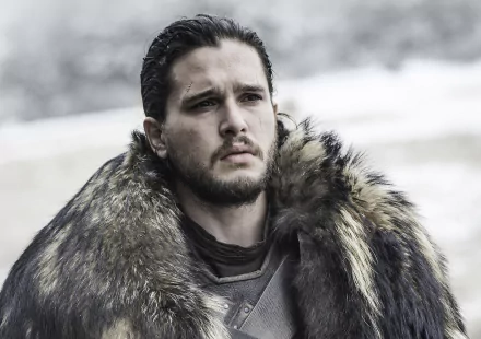 HD desktop wallpaper and background featuring Kit Harington as Jon Snow from the TV show Game of Thrones, shown wearing a fur cloak and looking determined.