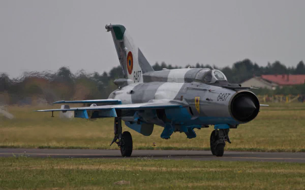 Mikoyan-Gurevich MiG-21 jet fighter warplane taxiing on a runway, captured in 4K Ultra HD with military markings on a clear day.