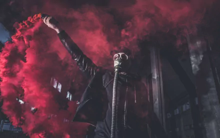 A dark, atmospheric scene featuring a figure wearing a gas mask, surrounded by vibrant red smoke. This HD image serves as a striking desktop wallpaper and background.