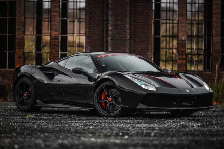 Black Ferrari 488 GTB by Edo Competition, front three-quarter shot with red brake calipers on wet pavement and an industrial brick backdrop — 4K Ultra HD PC desktop wallpaper