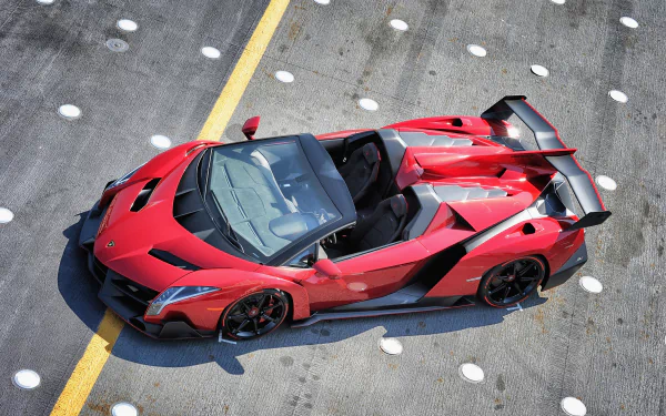 Red Lamborghini Veneno Roadster supercar parked on a concrete surface with a yellow line, captured in high-definition for a PC desktop wallpaper background.