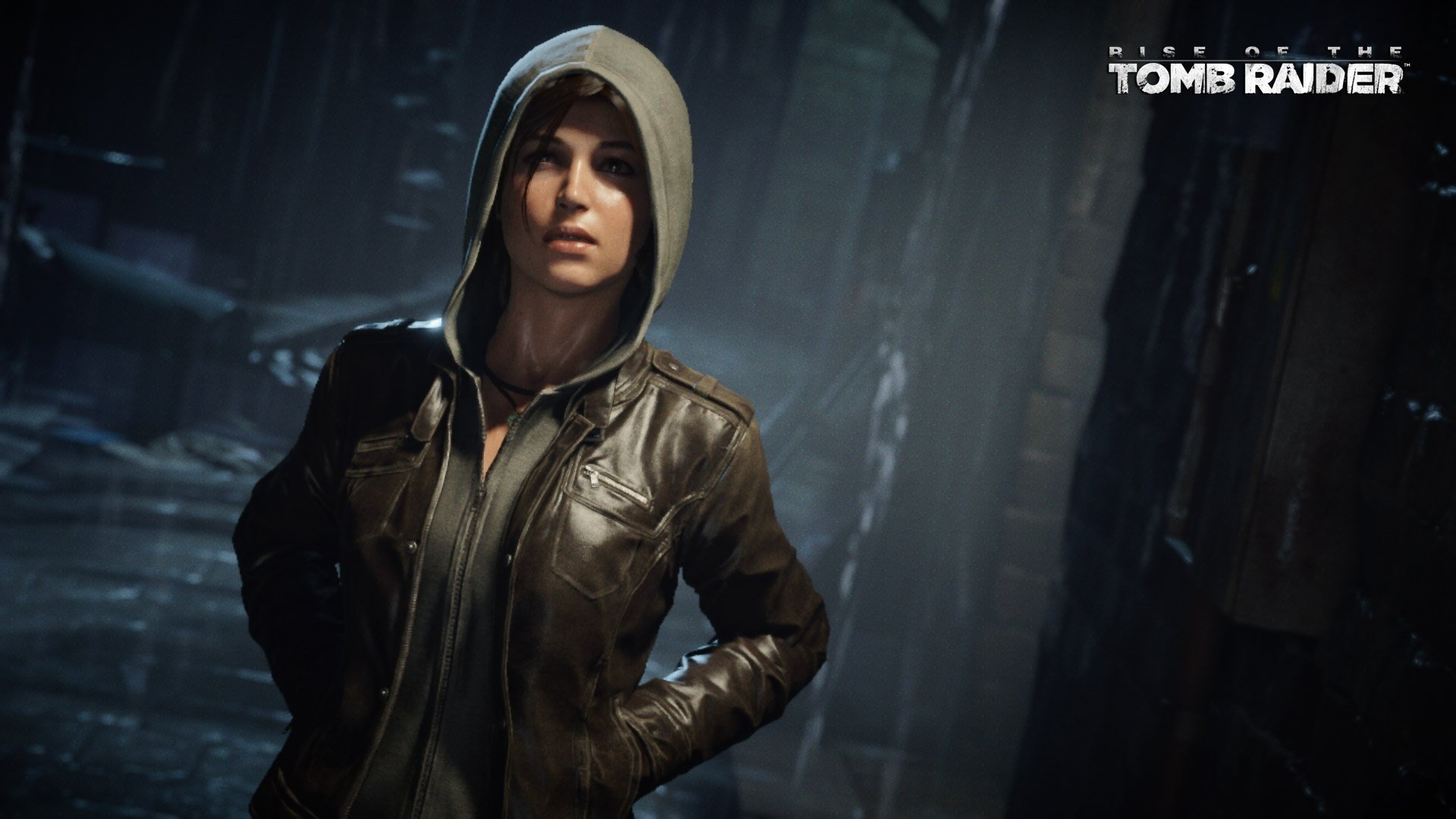 Lara Croft stands confidently in a dark, rain-soaked environment from Rise of the Tomb Raider, showcasing her iconic look in this HD desktop wallpaper.