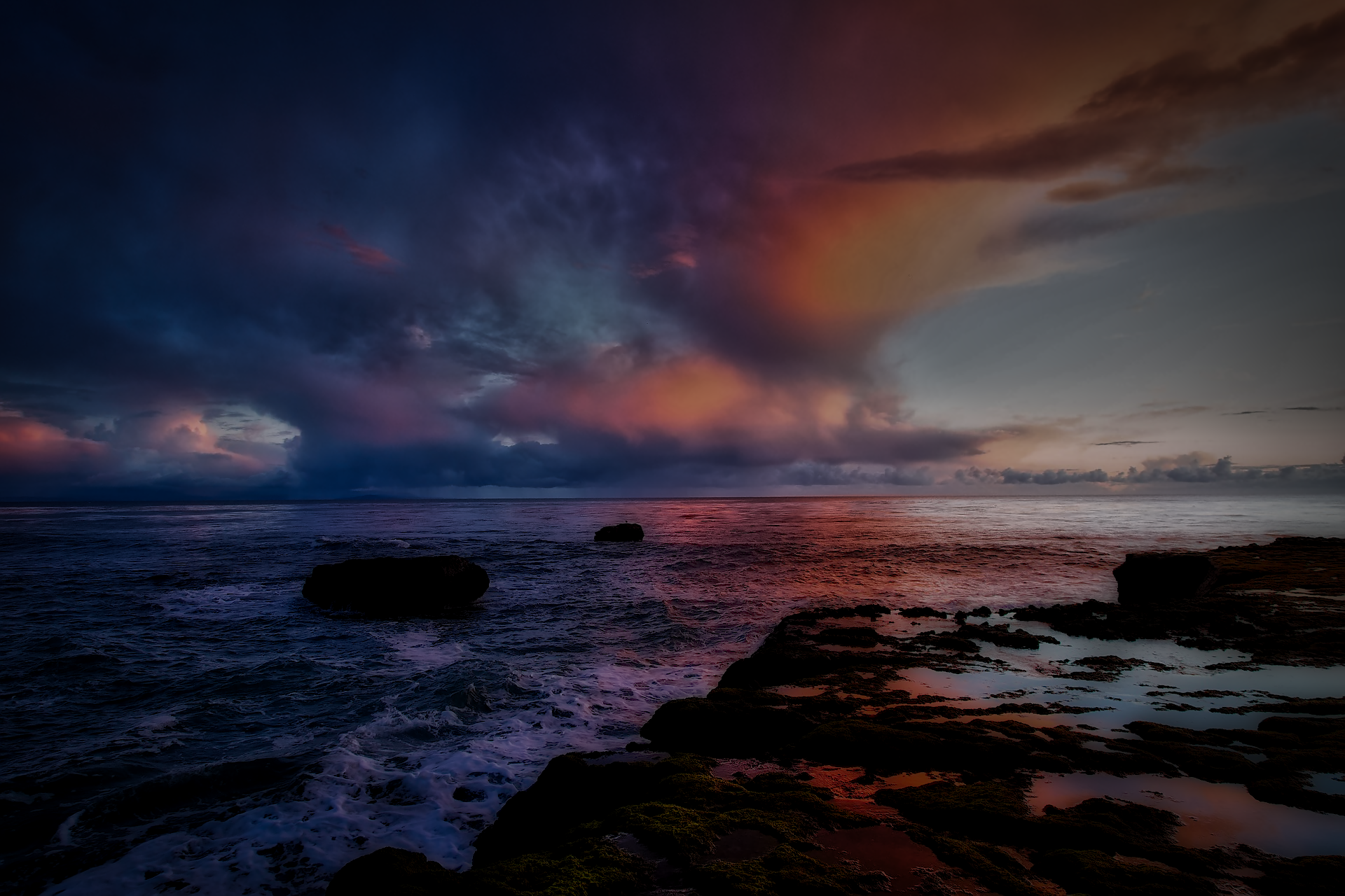 HDR HD PC desktop wallpaper: dramatic sunset sky over ocean, vivid HDR clouds and waves breaking on a rocky shoreline, coastal nature painted in deep blues and warm oranges.