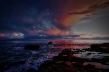 HDR HD PC desktop wallpaper: dramatic sunset sky over ocean, vivid HDR clouds and waves breaking on a rocky shoreline, coastal nature painted in deep blues and warm oranges.