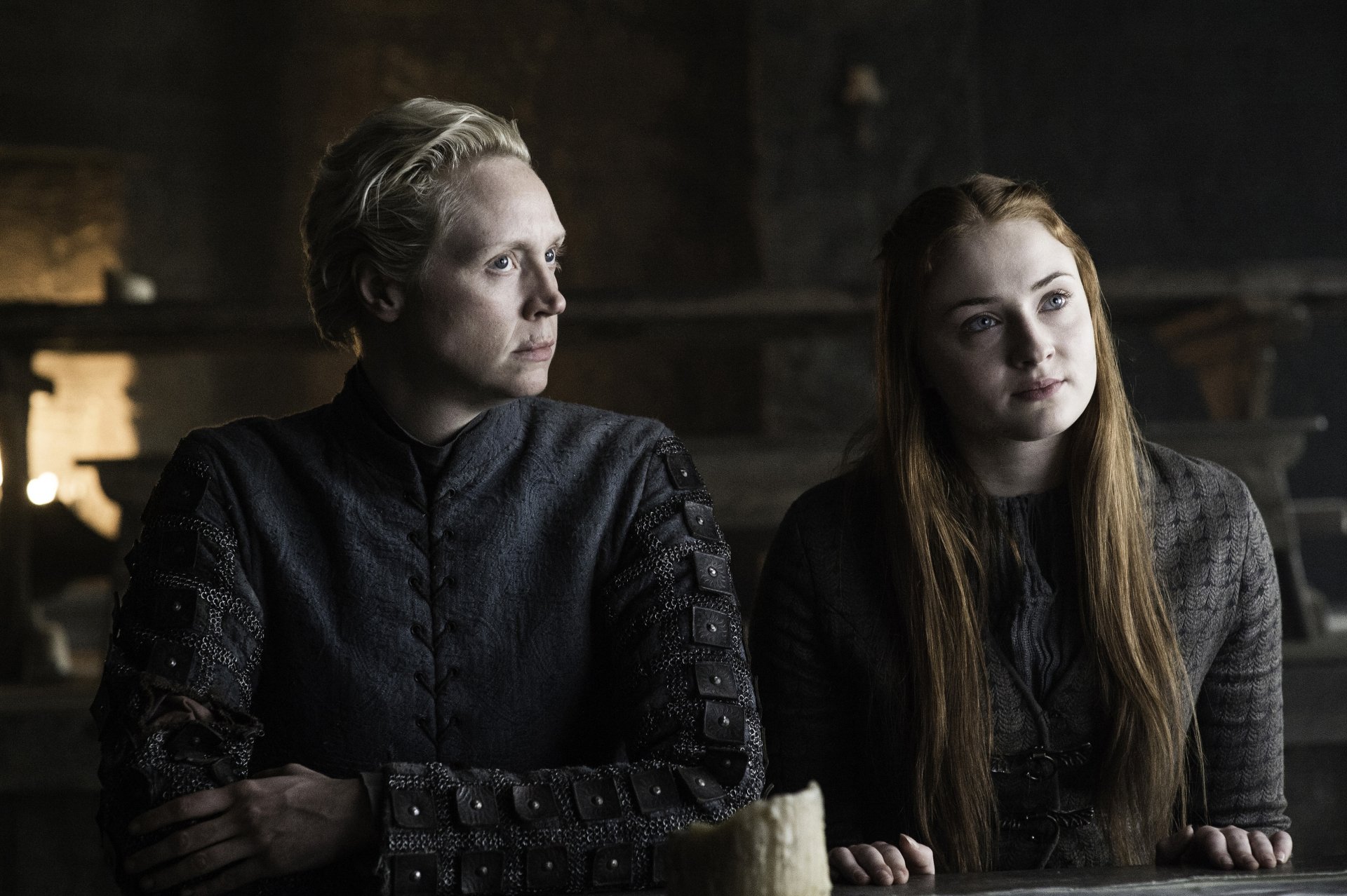 Brienne of Tarth and Sansa Stark from the TV show Game of Thrones sit side-by-side in a dim hall — 2K Quad HD PC desktop wallpaper/background.