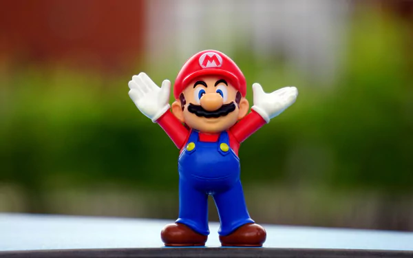 4K Ultra HD desktop wallpaper featuring a man-made Super Mario figurine with arms raised, set against a blurred natural background.