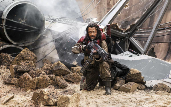 Jiang Wen as Saw Gerrera in Rogue One: A Star Wars Story, poised with a blaster amidst rubble and smoke, embodies the intense action of this iconic sci-fi film. 4K Ultra HD wallpaper.
