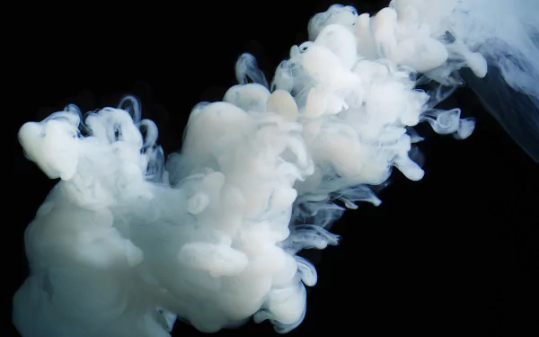 An abstract HD desktop wallpaper featuring swirling white smoke against a black background, creating a captivating and ethereal visual effect.