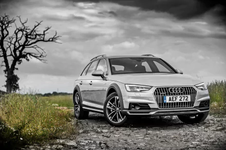 Silver Audi A4 allroad station wagon on a rural dirt road beneath a dramatic sky, high-detail 4K Ultra HD PC desktop wallpaper/background.