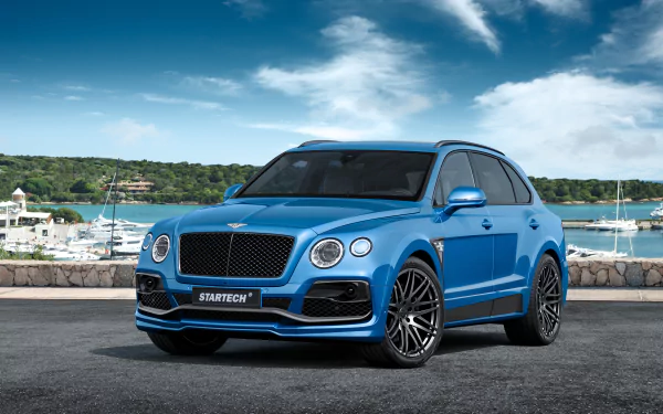 A blue Bentley Bentayga SUV parked near a waterfront, showcased in 4K Ultra HD as a desktop wallpaper and background.