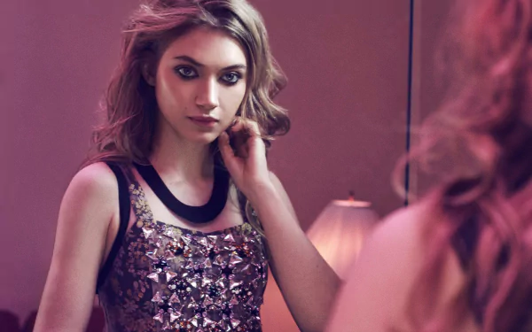 A stunning HD wallpaper featuring Imogen Poots, a brunette actress with captivating blue eyes, gazing thoughtfully in a mirror, exuding elegance and charm.