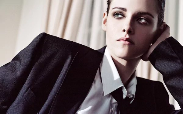 HD desktop wallpaper of American actress Kristen Stewart in a suit, showcasing her striking green eyes and confident expression.