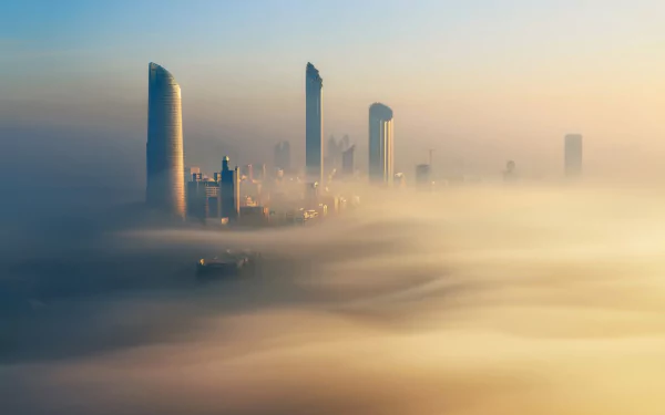 A foggy Dubai skyline with modern skyscrapers rising above thick mist, showcasing the city's iconic man-made architecture in the United Arab Emirates.