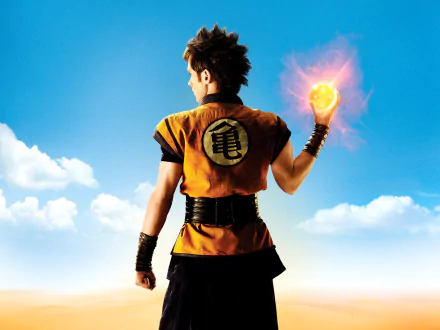 HD PC desktop wallpaper featuring Goku from the Dragonball Evolution movie, holding a glowing Dragon Ball against a bright sky background.