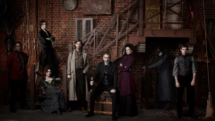 A dramatic ensemble from the TV show Penny Dreadful poses against a rustic, industrial backdrop, showcasing intense characters and moody atmosphere in HD wallpaper format.