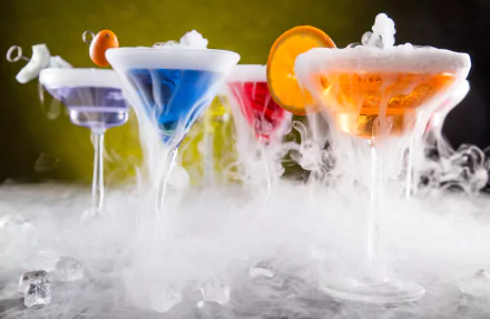 Vibrant cocktails in glassware emit swirling smoke against a contrasting backdrop, creating a striking 4K Ultra HD desktop wallpaper of drinks and food artistry.