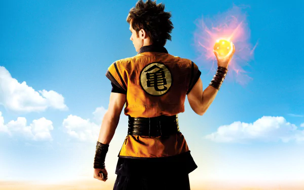 HD PC desktop wallpaper featuring Goku from the Dragonball Evolution movie, holding a glowing Dragon Ball against a bright sky background.