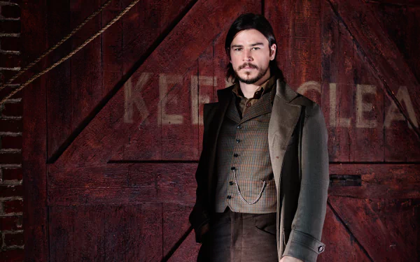 A character from the TV show Penny Dreadful stands confidently in front of a rustic red backdrop, exuding a sense of mystery and charm. High-definition desktop wallpaper for fans.