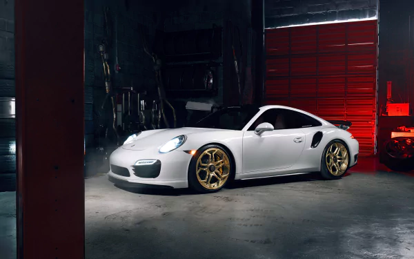 White Porsche 911 Turbo with gold rims parked inside a dimly lit garage, captured in a high-definition desktop wallpaper style.
