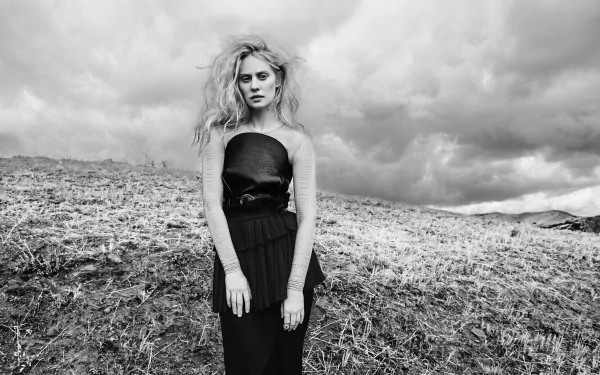 Black & White 5K Ultra HD PC desktop wallpaper: outdoor woman model stands on a windswept hillside under dramatic clouds in a strapless black dress.