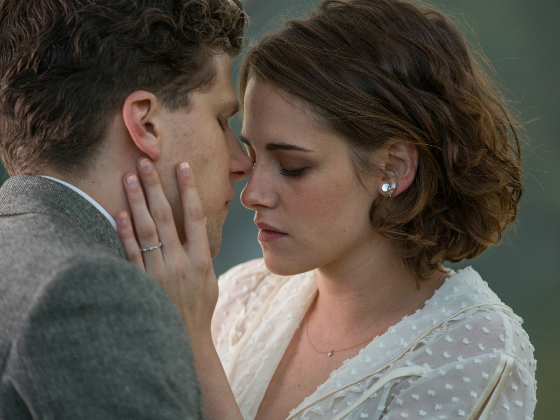 HD desktop wallpaper featuring Kristen Stewart and Jesse Eisenberg in a close, intimate scene from the movie Cafe Society.
