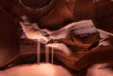 HD desktop wallpaper showcasing the smooth, flowing sandstone formations and soft sand streams inside Arizona's Antelope Canyon, highlighting the natural beauty of this iconic canyon.
