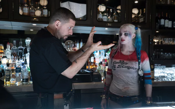 Harley Quinn, portrayed by Margot Robbie, engages in a lively exchange at a bar in this dramatic scene from Suicide Squad, captured in stunning 4K Ultra HD quality.