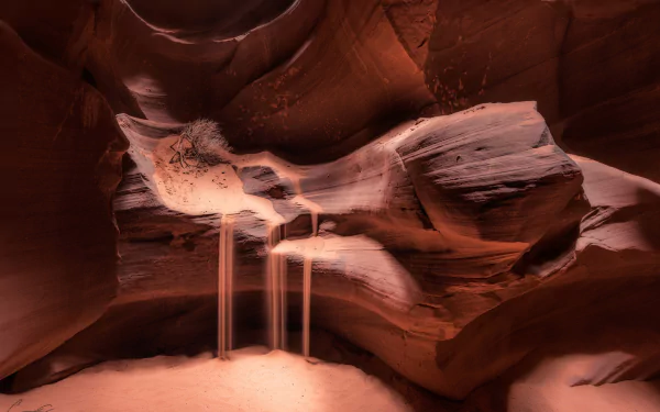 HD desktop wallpaper showcasing the smooth, flowing sandstone formations and soft sand streams inside Arizona's Antelope Canyon, highlighting the natural beauty of this iconic canyon.