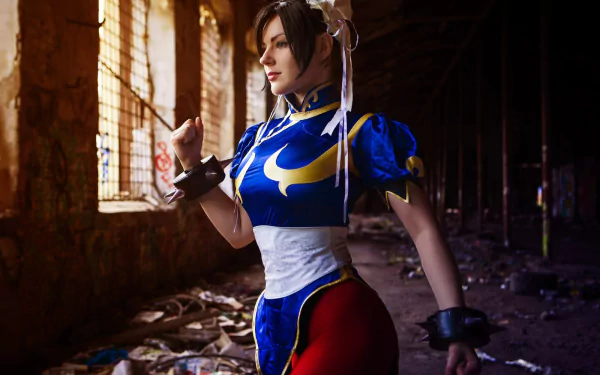 HD PC desktop wallpaper featuring a woman cosplaying Chun-Li from Street Fighter in a detailed blue costume inside a dimly lit, abandoned building.