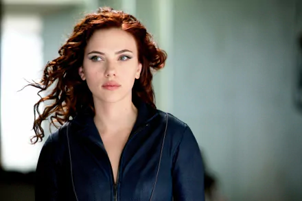 HD desktop wallpaper featuring Scarlett Johansson from the movie Iron Man 2, with flowing red hair and a dark jacket, gazing into the distance.
