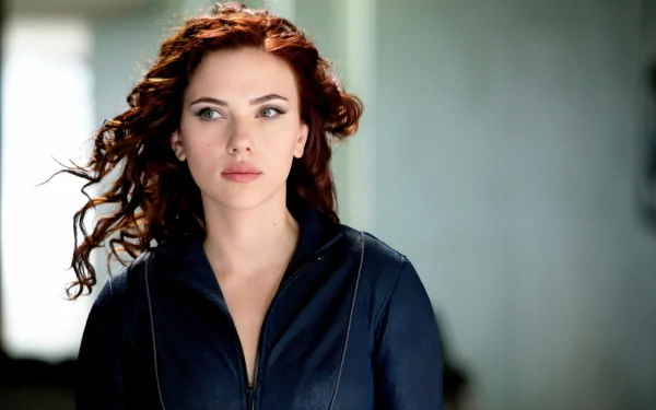 HD desktop wallpaper featuring Scarlett Johansson from the movie Iron Man 2, with flowing red hair and a dark jacket, gazing into the distance.