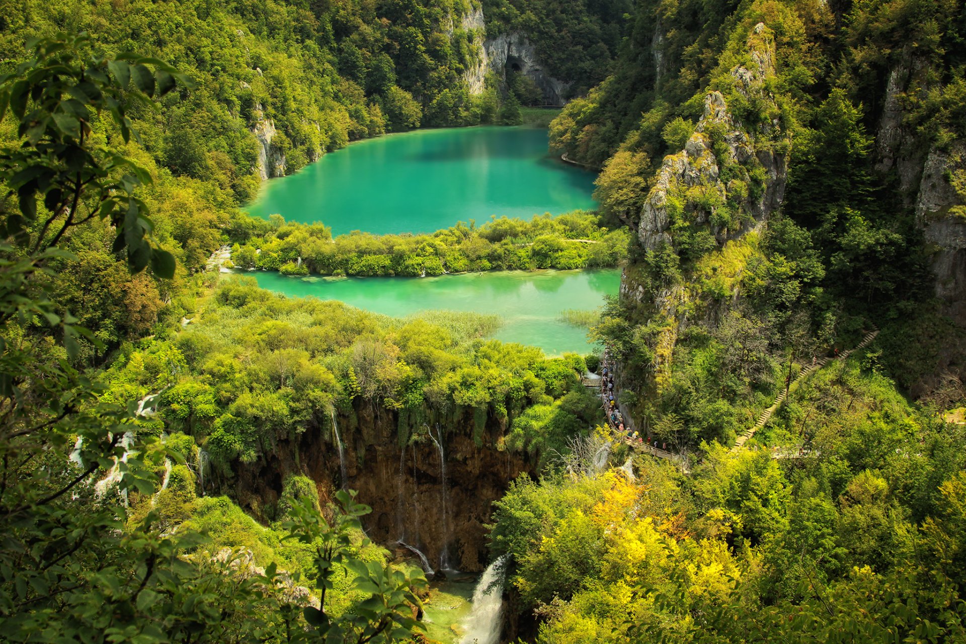 HD PC desktop wallpaper of Plitvice Lakes National Park: emerald tiered lakes and waterfalls nestled among dense forest and trees.