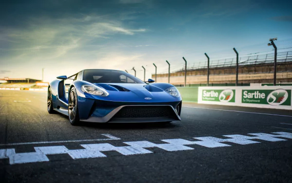 A sleek blue Ford GT supercar captured in 4K Ultra HD on a racetrack near the finish line, showcasing its aerodynamic design and powerful stance.