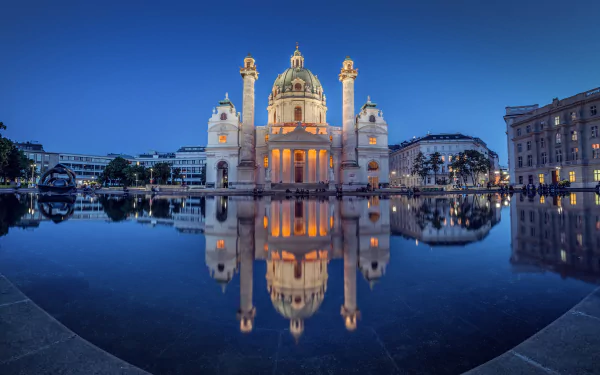 A stunning night view of Karlskirche in Vienna, Austria, beautifully reflected in still water, showcasing its architectural grandeur and serene ambiance.