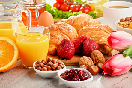 A vibrant still life featuring breakfast items: croissants, strawberries, nuts, honey, jam, orange juice, an egg, and tulips, creating a colorful and inviting morning scene.