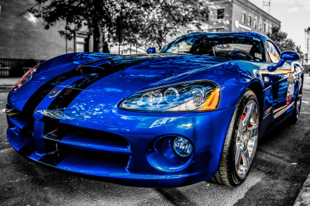 A striking blue Dodge Viper with black racing stripes parked on a street, featured as an HD PC desktop wallpaper showcasing this powerful Dodge vehicle.