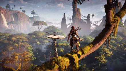 HD desktop wallpaper of Aloy from the video game Horizon Zero Dawn, standing on a mossy branch overlooking a lush, misty forest with tall rock formations in the distance.