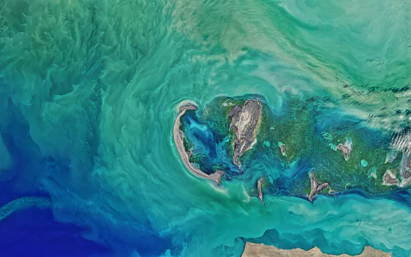 A vibrant 8K Ultra HD aerial view of the Caspian Sea showcasing swirling ocean currents and natural land formations from space.