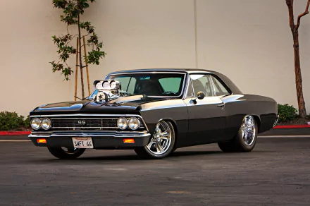 A sleek 1966 Chevrolet Chevelle muscle car, featuring a powerful hood-mounted supercharger, parked against a minimalist background, showcasing its classic hot rod design.