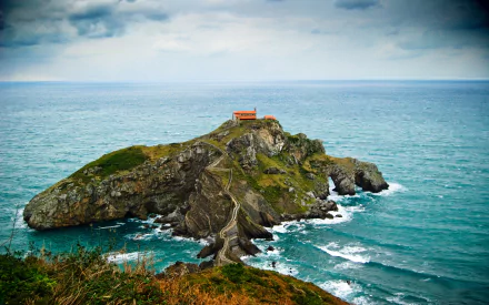 Gaztelugatxe island on the Bay of Biscay, Spain — rocky islet with chapel and winding path, sea and ocean horizon with waves; 4K Ultra HD PC desktop wallpaper of nature.