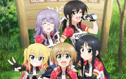 HD PC desktop wallpaper of Long Riders! anime: five cheerful girls in matching cycling jerseys posing in front of a park sign in a sunlit forest.