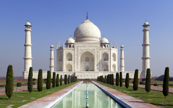 HD desktop wallpaper featuring the iconic Taj Mahal, a monumental dome structure in India, surrounded by lush green park grounds and a reflecting pool.
