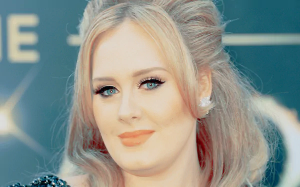 HD PC desktop wallpaper featuring a close-up of British singer Adele with blonde hair and a soft smile, capturing her elegant music star presence.