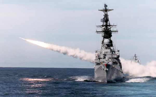 HD wallpaper of the German Navy destroyer Lütjens (D185) launching a missile, showcasing the warship's military power on the open sea.