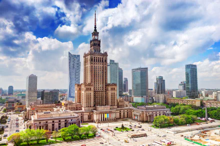 A vibrant 4K Ultra HD view of Warsaw's skyline, featuring iconic skyscrapers and man-made buildings under a partly cloudy sky.