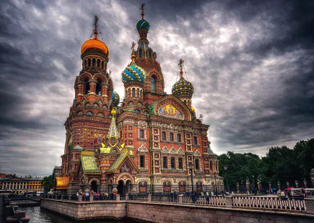 Church of the Savior on Blood, Saint Petersburg, Russia — ornate Russian Orthodox church with colorful onion domes and intricate architecture under stormy sky; HD PC desktop wallpaper background.