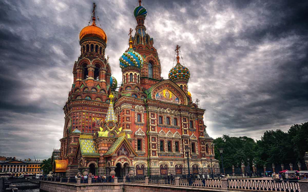 Church of the Savior on Blood, Saint Petersburg, Russia — ornate Russian Orthodox church with colorful onion domes and intricate architecture under stormy sky; HD PC desktop wallpaper background.