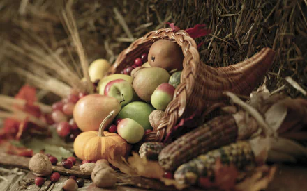 A still life HD desktop wallpaper featuring a cornucopia basket filled with apples, pears, nuts, corn, and autumn leaves, capturing the essence of fall and Thanksgiving.