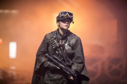 Jyn Erso, portrayed by Felicity Jones, stands in a dramatic scene from Rogue One: A Star Wars Story, showcasing a gritty atmosphere in 4K Ultra HD.