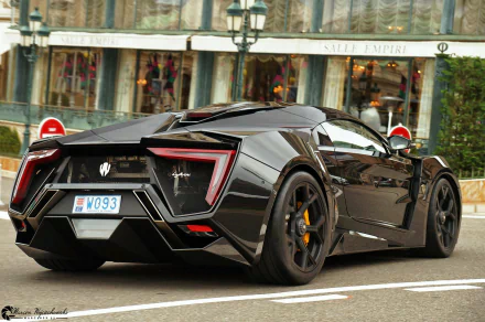 HD PC desktop wallpaper featuring a sleek black Lykan HyperSport parked on a city street, showcasing its futuristic design and sharp rear details.